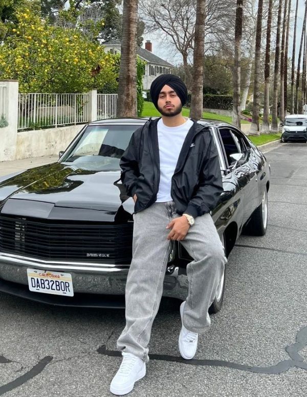 Canada Based Singer Shubh Posing Standing in front of a car
